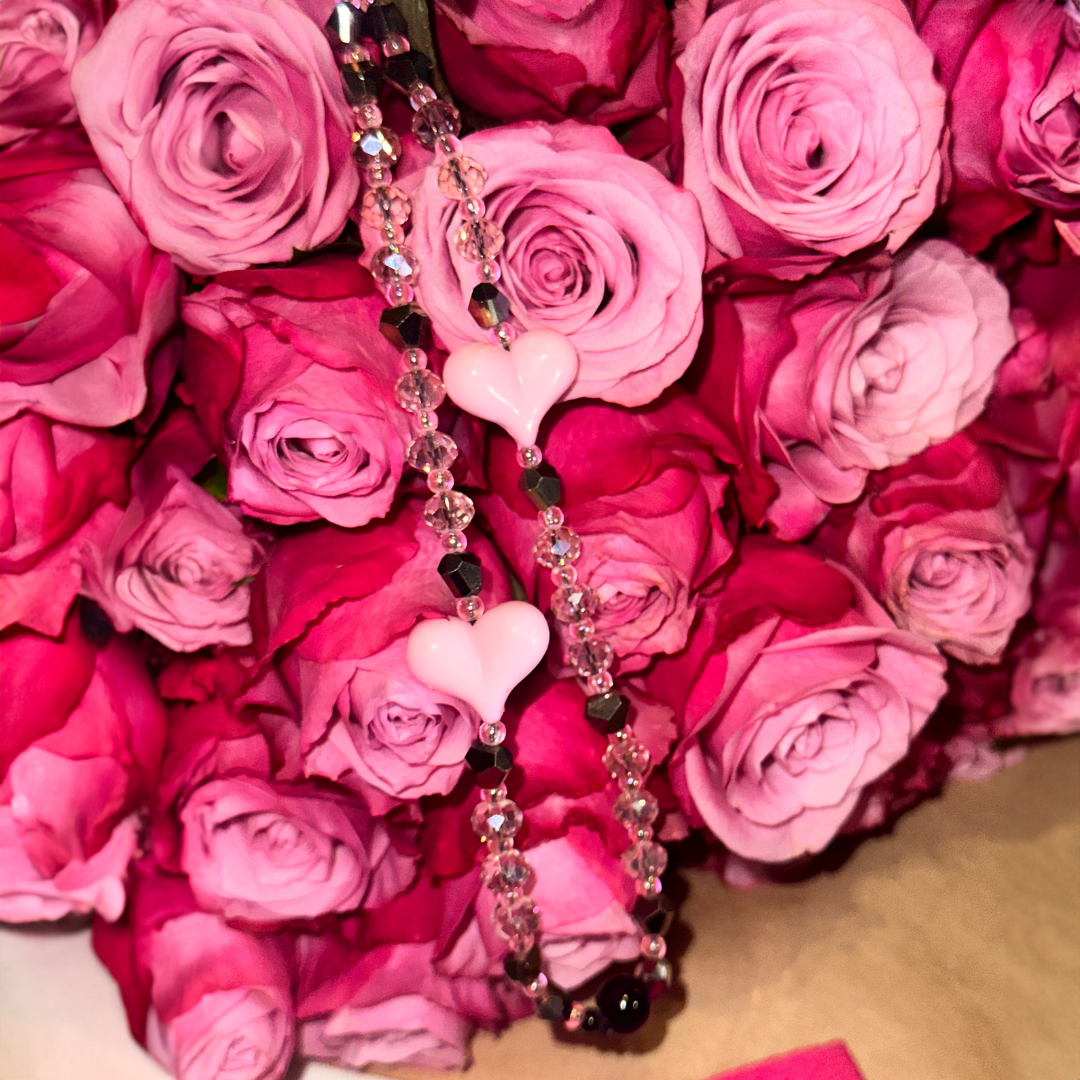 pink roses with phone charm in the middle