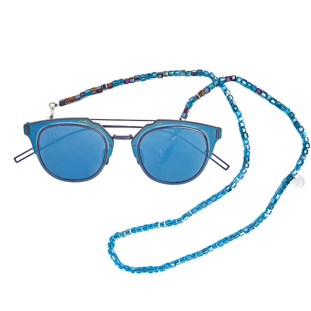 Blue hues in cube crystals on chain attached to fine blue sunglasses